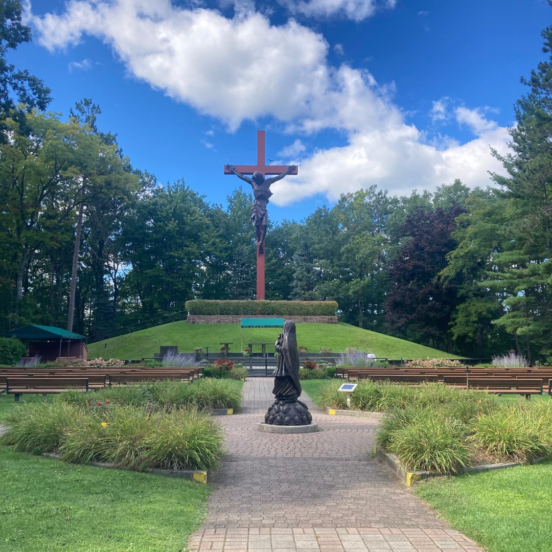 Discover Cross in the Woods in Indian River, Michigan — towering redwood cross, eight serene shrines, and a one-of-a-kind Nun Doll Museum.