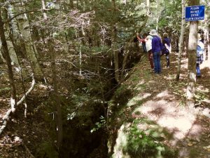 people exploring earth crack Michigan karst trail