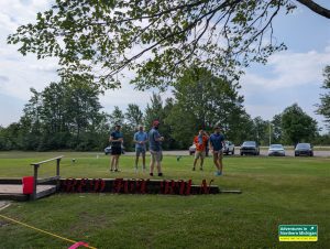 Guy watching Dom, Patrick, Alex and Johnny tee off at the first hole of Red Fox Run Golf Course in Gwinn, Michigan