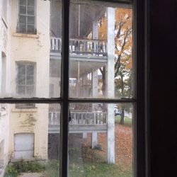 Looking out a window in one of the Buildings of Grand Traverse Commons at another building next door