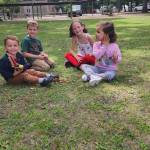 Kids sitting on lawn